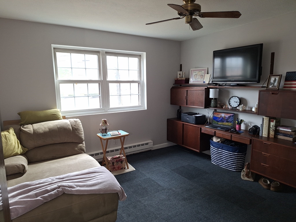 39 West Street, Unit B1 Randolph, MA 02368 - Photo 13 of 15 a bedroom with furniture and a flat screen tv