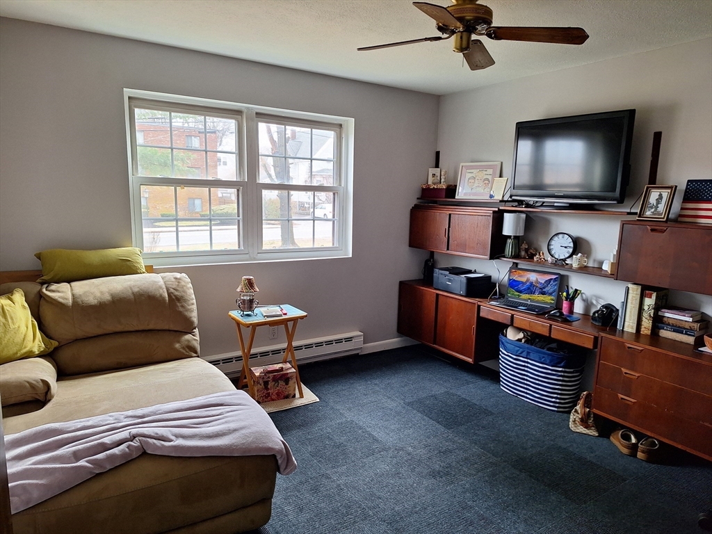 39 West Street, Unit B1 Randolph, MA 02368 - Photo 14 of 15 a bedroom with furniture and a flat screen tv