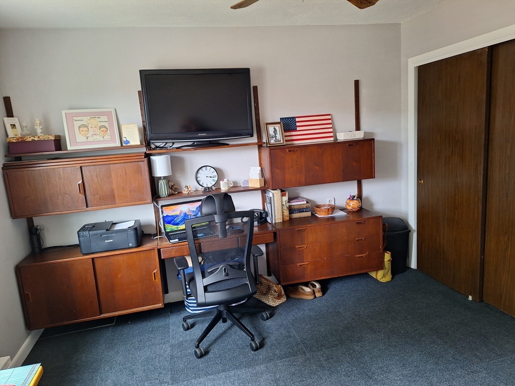 39 West Street, Unit B1 Randolph, MA 02368 - Photo 15 of 15 a room with furniture and a flat screen tv