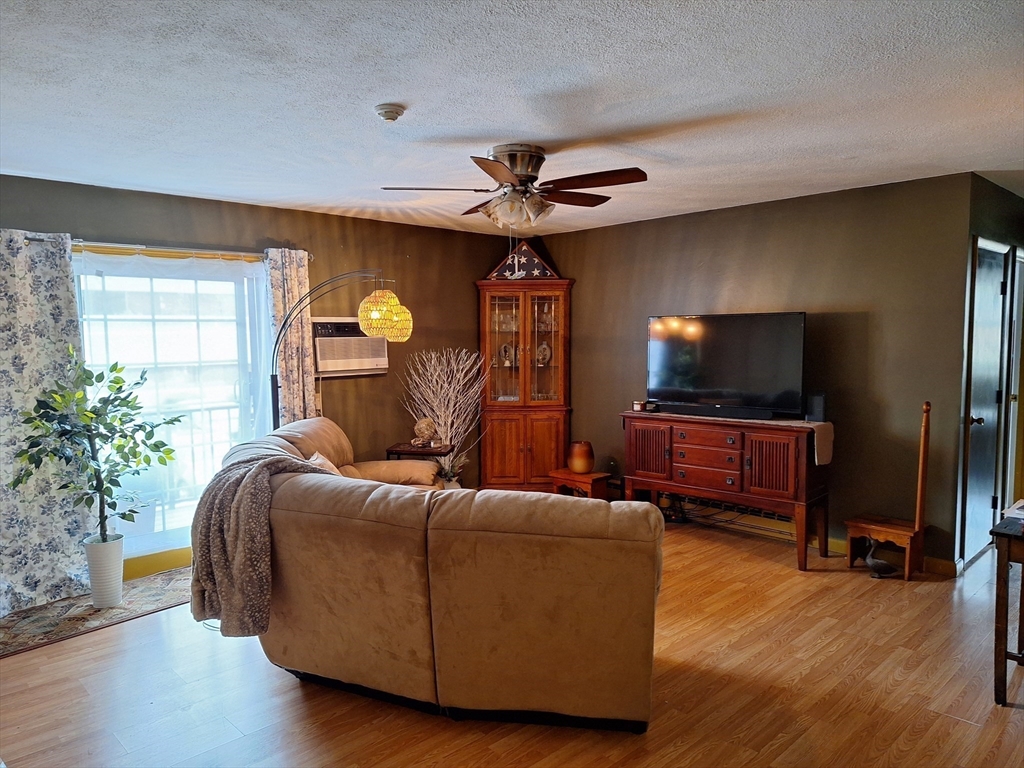 39 West Street, Unit B1 Randolph, MA 02368 - Photo 4 of 15 a living room with furniture and a flat screen tv