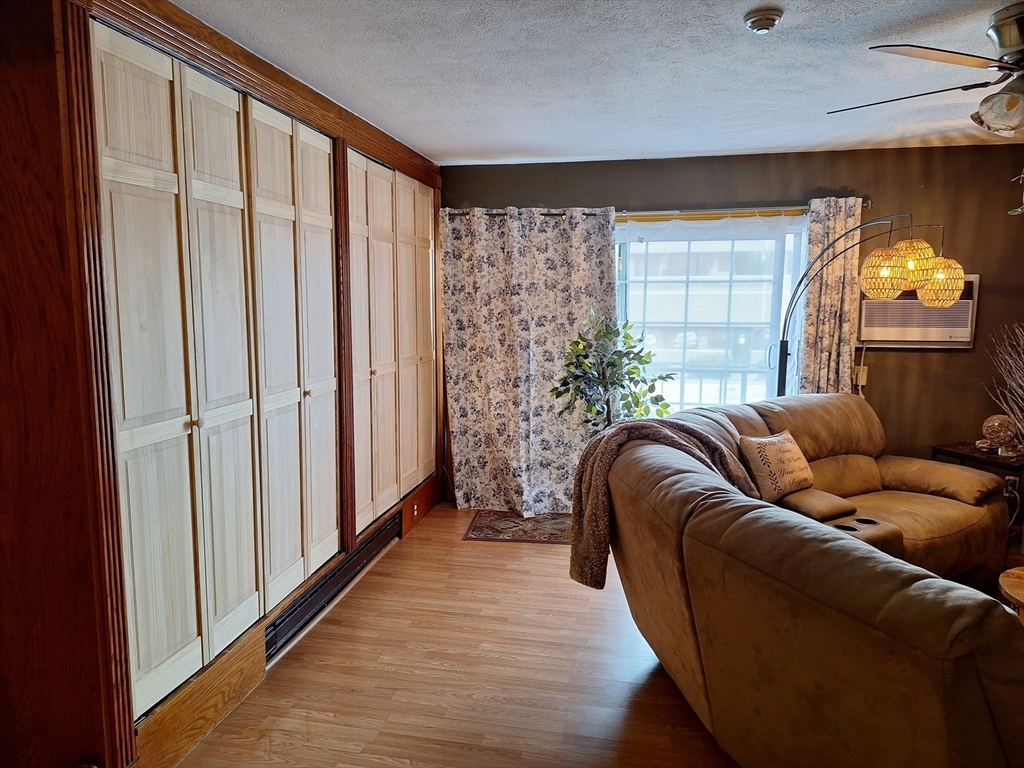 39 West Street, Unit B1 Randolph, MA 02368 - Photo 5 of 15 a living room with furniture and a window