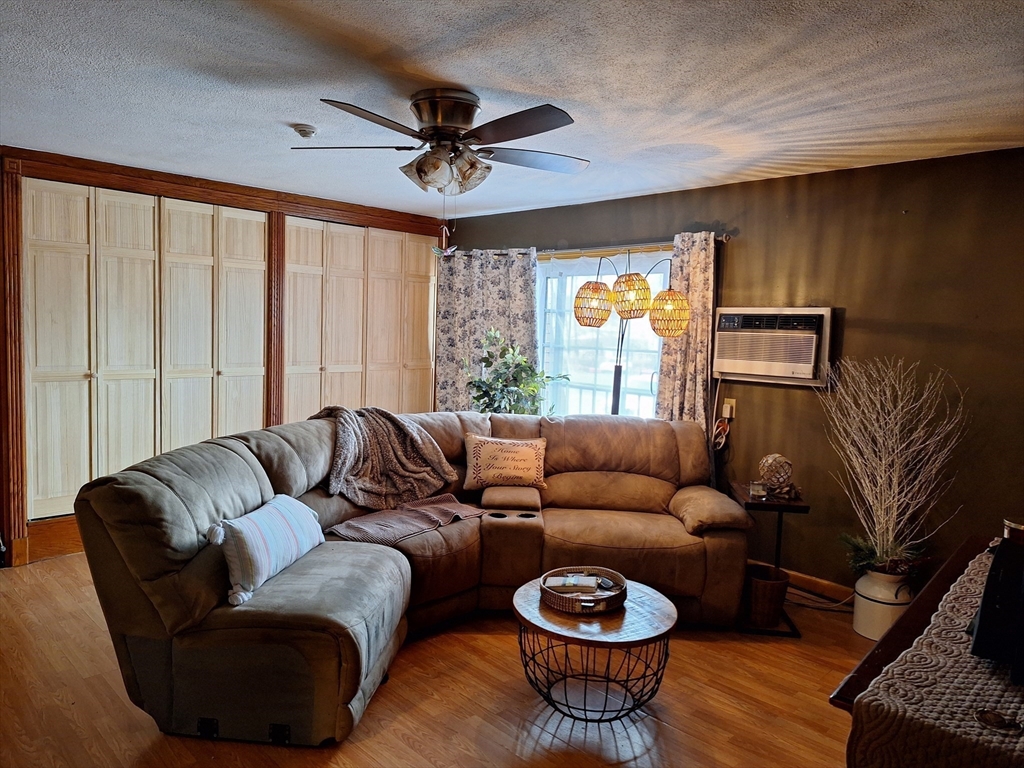 39 West Street, Unit B1 Randolph, MA 02368 - Photo 6 of 15 a living room with furniture and a window