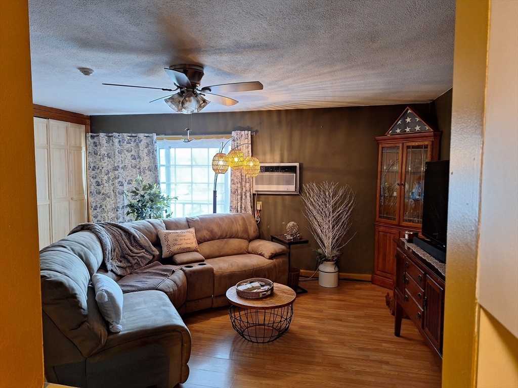 39 West Street, Unit B1 Randolph, MA 02368 - Photo 7 of 15 a living room with furniture and a window