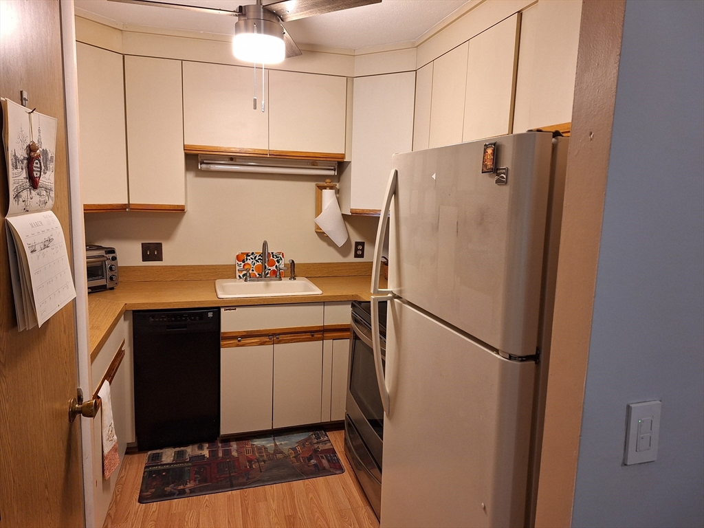 39 West Street, Unit B1 Randolph, MA 02368 - Photo 8 of 15 a white refrigerator freezer sitting inside of a kitchen