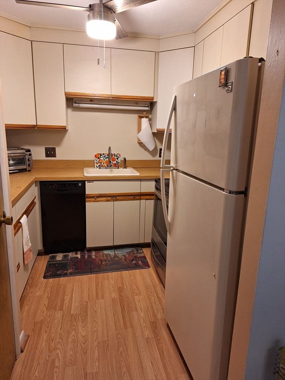 39 West Street, Unit B1 Randolph, MA 02368 - Photo 9 of 15 a white refrigerator freezer sitting inside of a kitchen