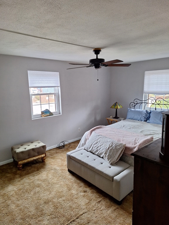 39 West Street, Unit B1 Randolph, MA 02368 - Photo 10 of 15 a bedroom with a bed and a ceiling fan