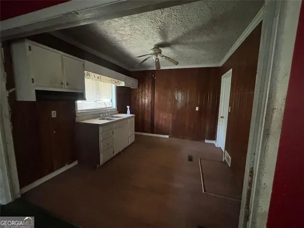 a kitchen with stainless steel appliances granite countertop a refrigerator a sink and a stove