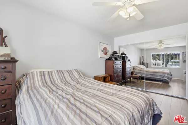 a bedroom with bed and a chandelier