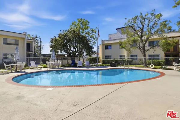 a view of outdoor space with swimming pool and seating