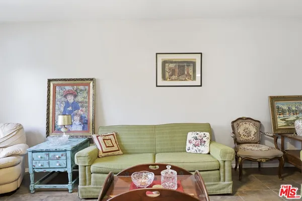 a living room with furniture and a chair