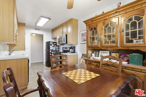 a kitchen with a table chairs stove and refrigerator