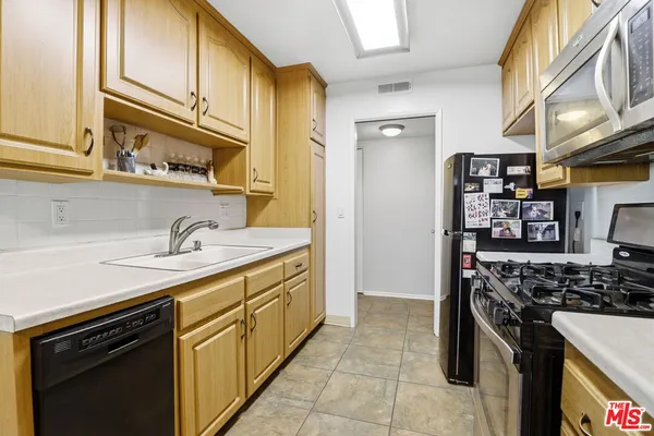 a kitchen with stainless steel appliances granite countertop a stove and a sink