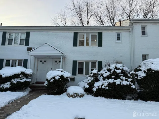 a couple of cars parked in front of a house