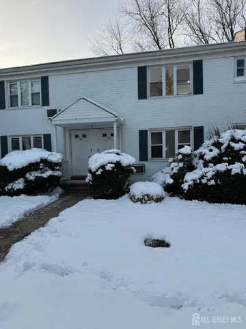 a car parked in front of white house