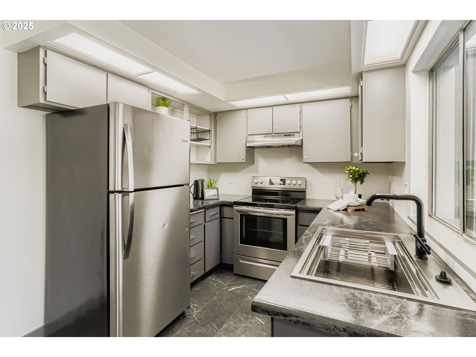 650 Southwest Meadow Drive, Unit 106 Beaverton, OR 97006 - Photo 7 of 29 a kitchen with a refrigerator sink stove and cabinets