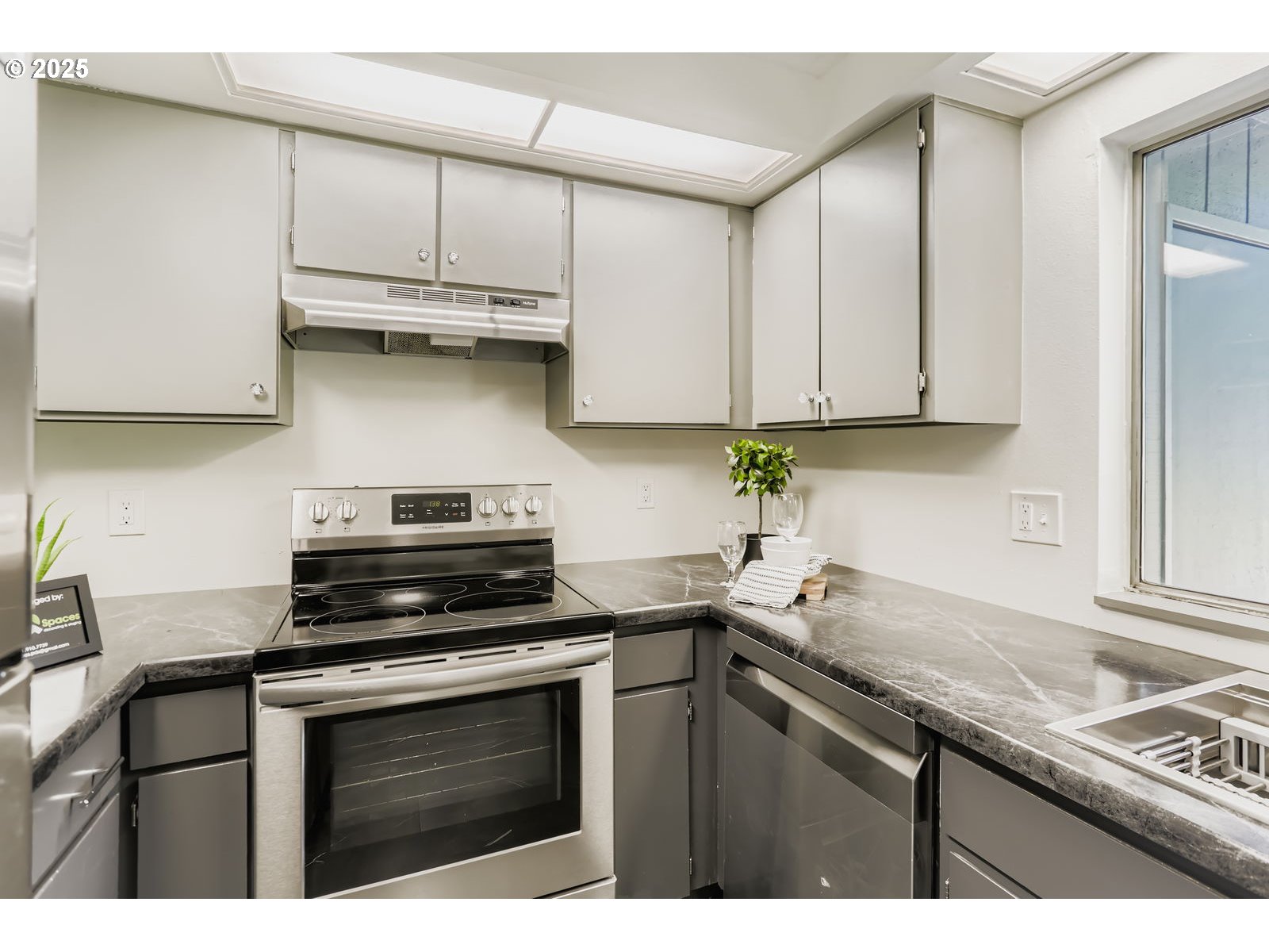 650 Southwest Meadow Drive, Unit 106 Beaverton, OR 97006 - Photo 8 of 29 a kitchen with stainless steel appliances granite countertop a sink stove and cabinets