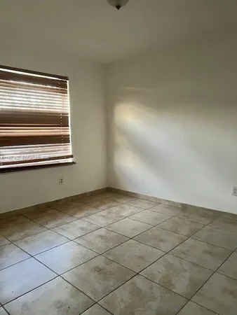 an empty room with a empty space and a window