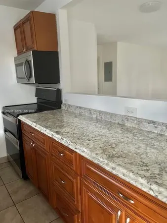 a view of kitchen with granite countertop sink and dishwasher