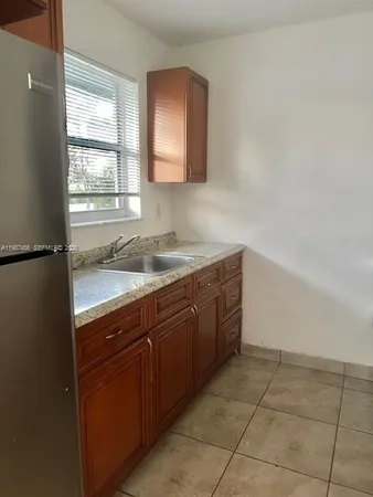 a bathroom with a sink vanity and mirror
