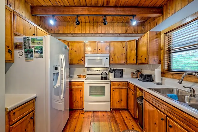 a view of a patio with table and chairs and wooden floor