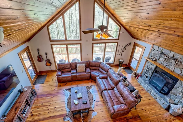 a view of a livingroom with furniture hardwood floor and a window