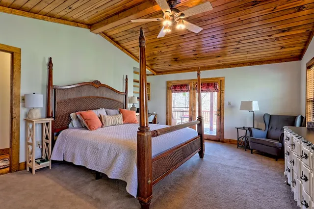 a pathway of a house with a yard and wooden fence