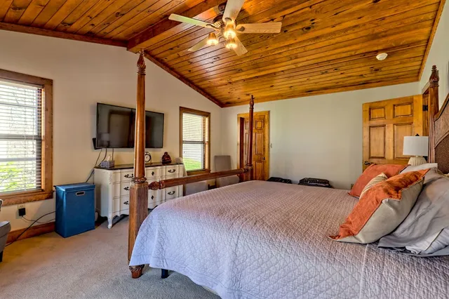 a bed room with furniture and a flat screen tv
