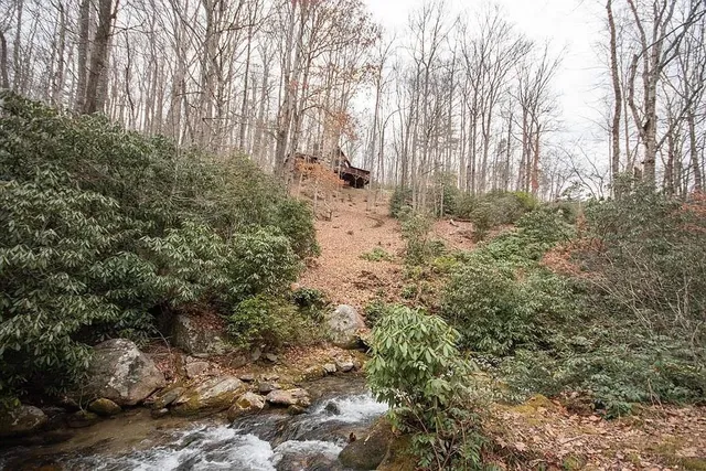 a living room with furniture a flat screen tv and wooden floor