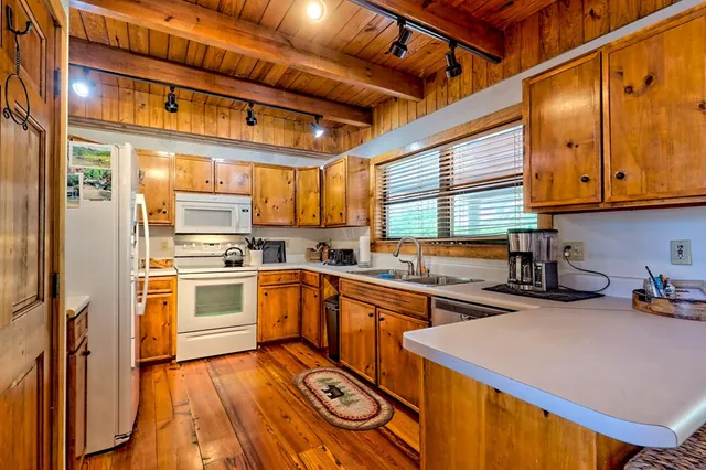 a view of a house with a small yard and wooden fence