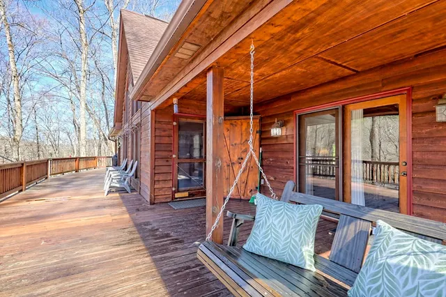 a very nice looking room with many windows and furniture