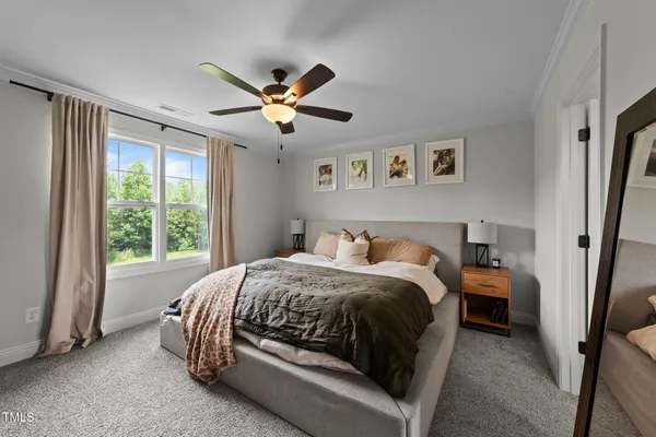 a spacious bedroom with a bed and a large window