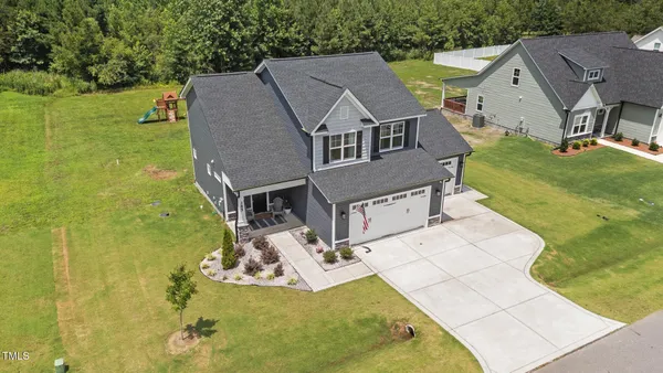 an aerial view of a house with a garden and swimming pool