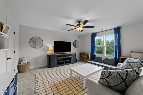 a bedroom with a bed and a television