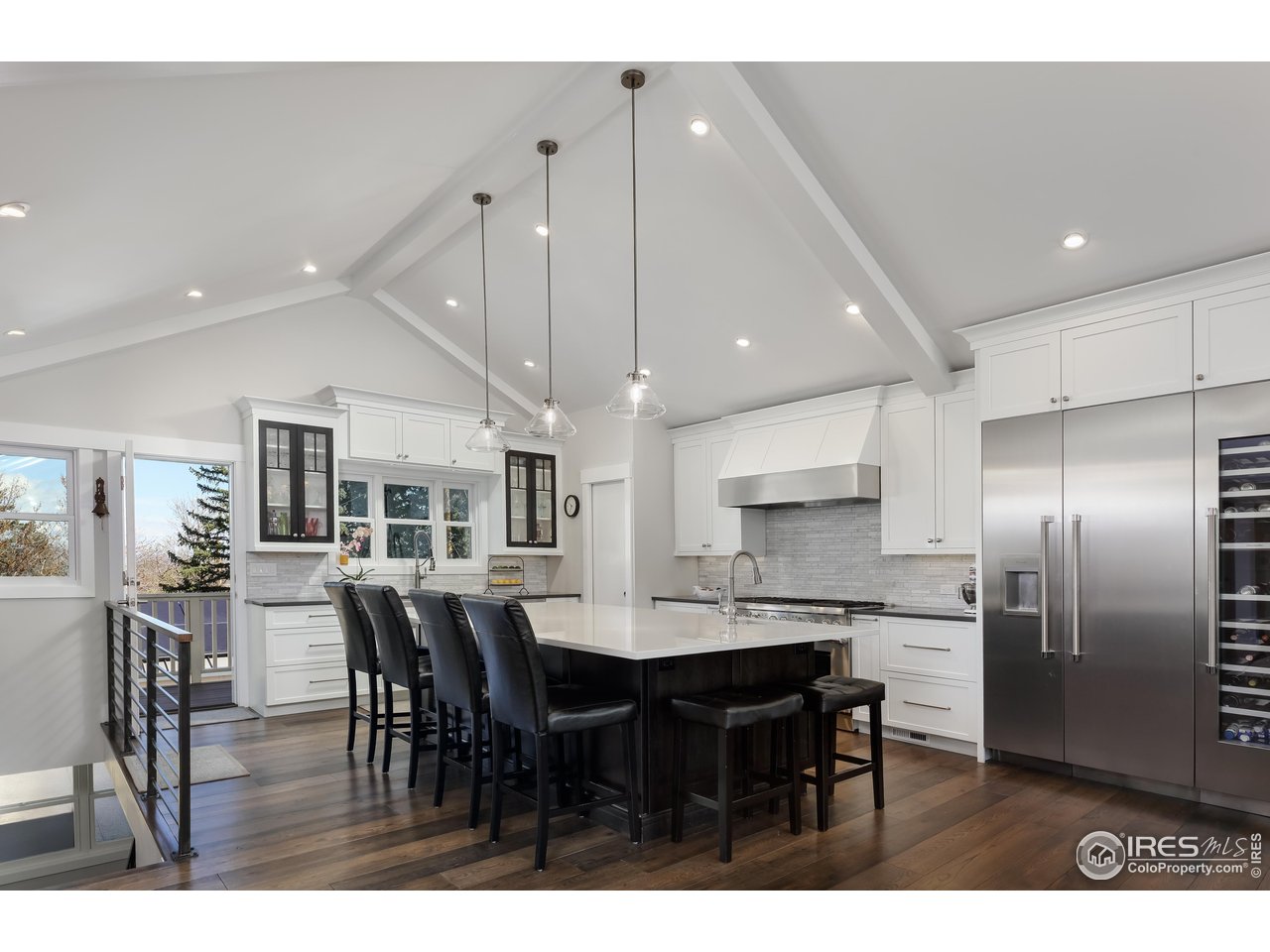 709 Baseline Road Boulder, CO 80302 - Photo 13 of 40 a kitchen with kitchen island a dining table chairs and cabinets
