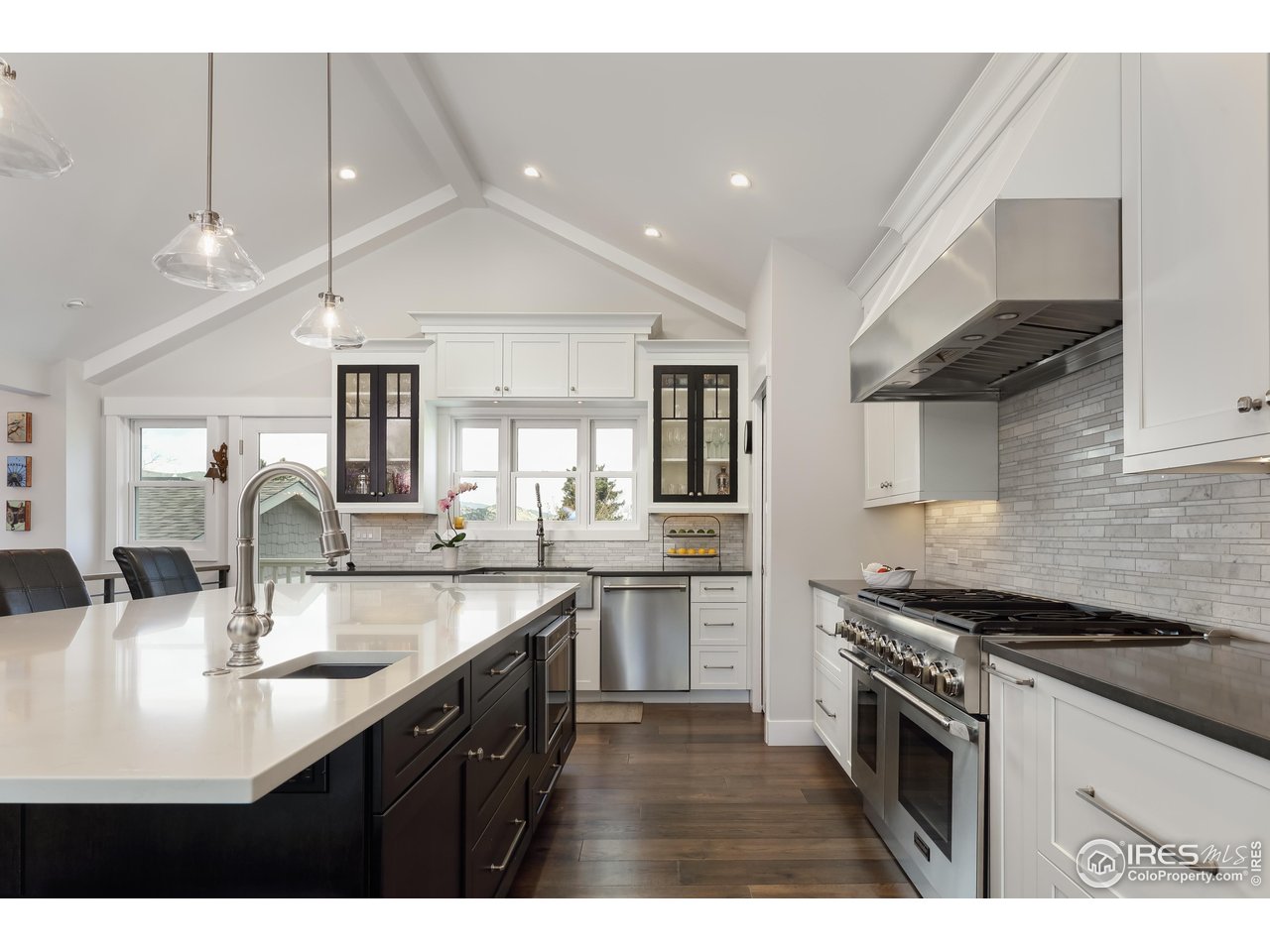709 Baseline Road Boulder, CO 80302 - Photo 16 of 40 a kitchen with stainless steel appliances kitchen island a sink stove and cabinets
