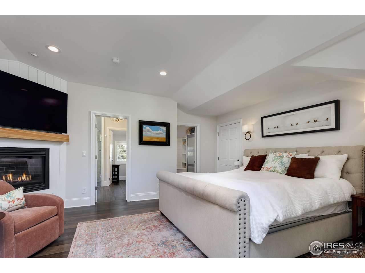 709 Baseline Road Boulder, CO 80302 - Photo 24 of 40 a bedroom with a bed a couch and a flat screen tv