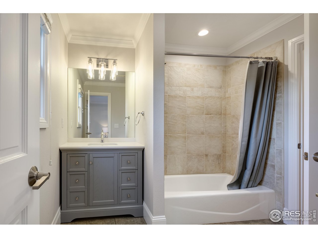 709 Baseline Road Boulder, CO 80302 - Photo 34 of 40 a bathroom with a granite countertop sink a mirror a bathtub and shower