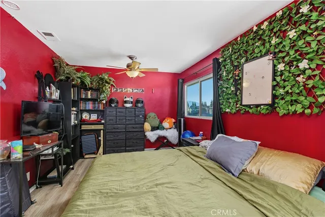 a bed room with a bed and a chair