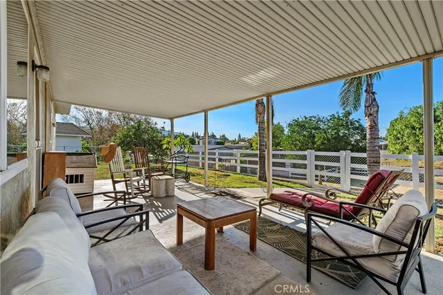 a view of a patio with a table chairs and a backyard