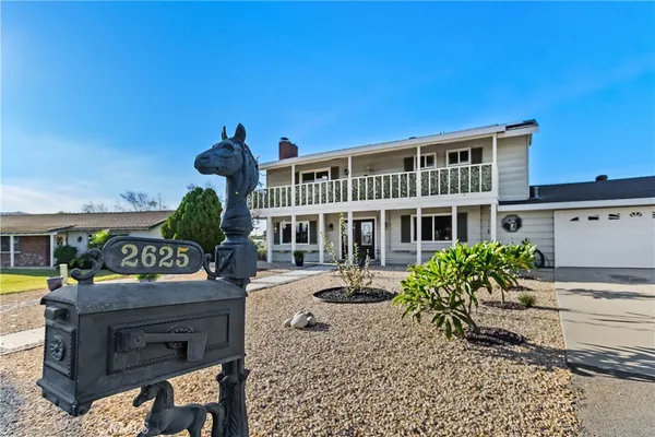 a front view of a house with a garden