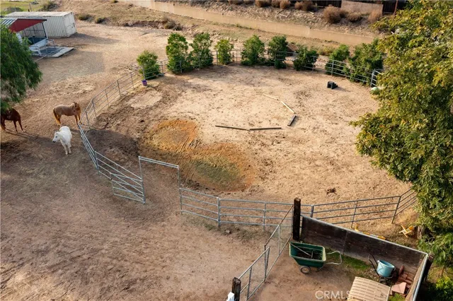 an aerial view of a house with a yard and lake