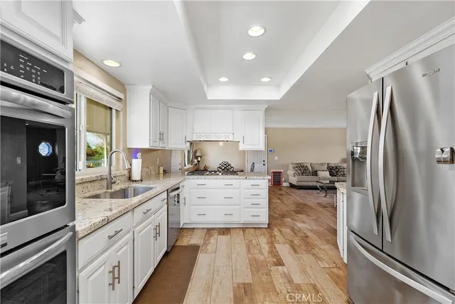 a kitchen with a refrigerator and a sink