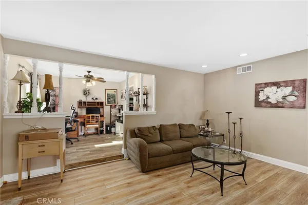 a living room with furniture and wooden floor