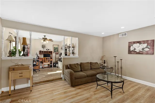 a living room with furniture and wooden floor