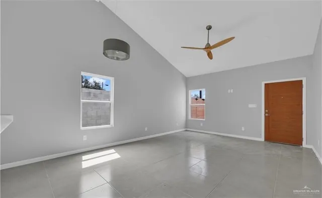 an empty room with windows and closet