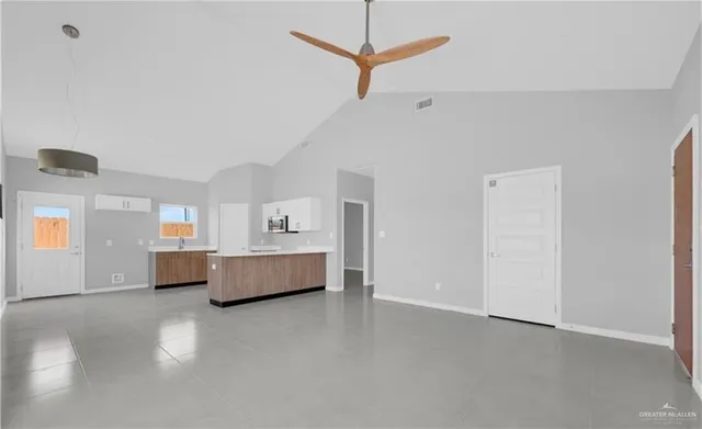 a living room with furniture and a ceiling fan