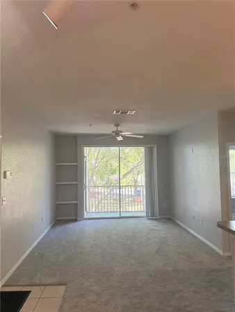 an empty room with windows and closet