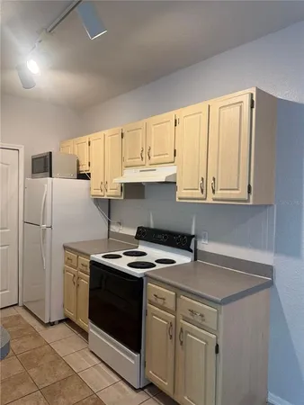 a kitchen with stainless steel appliances a stove a sink and cabinets