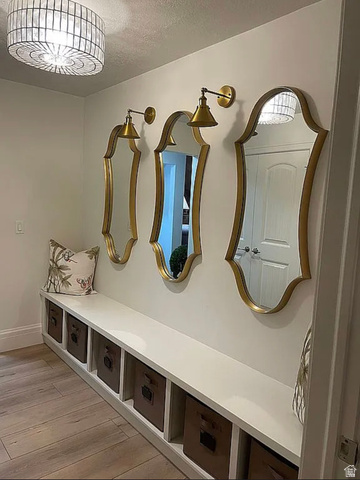 838 East Mountain Road North Ogden, UT 84414 - Photo 12 of 37 Built-in hallway bench with open cubby storage, wood-finish flooring, and a decorative ceiling fixture