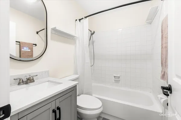 a bathroom with a sink vanity mirror and shower